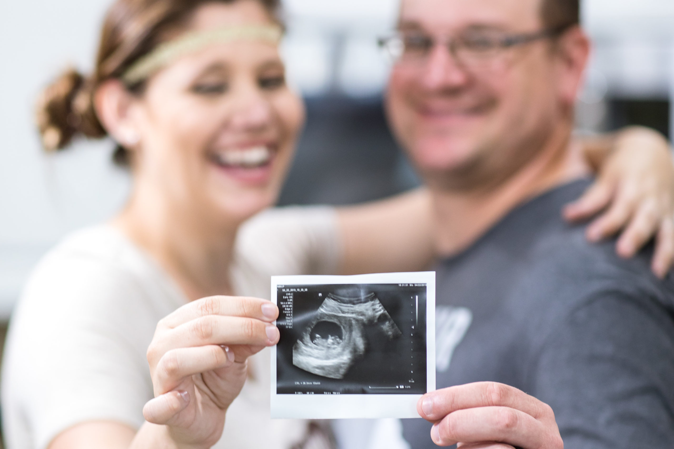 mother and father announcing pregnancy after ivf journey